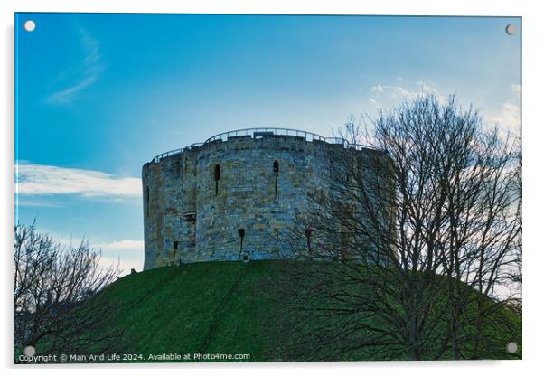 Medieval stone tower on a grassy hill with bare trees against a blue sky with clouds in York, UK. Acrylic by Man And Life
