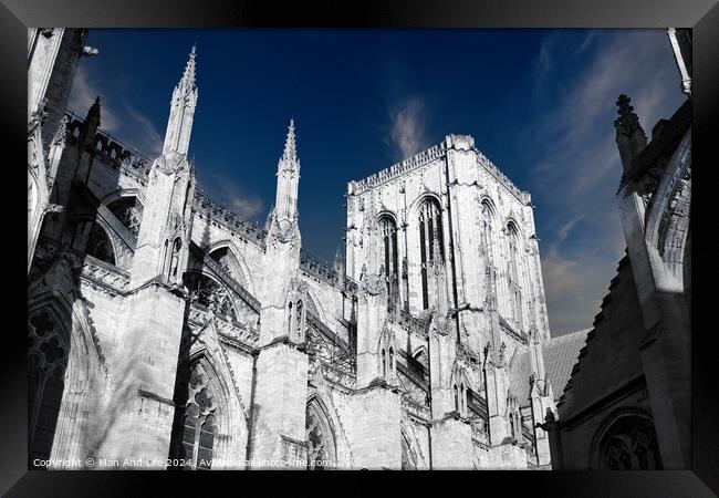 Gothic cathedral architecture with spires against a blue sky with clouds in York, UK. Framed Print by Man And Life