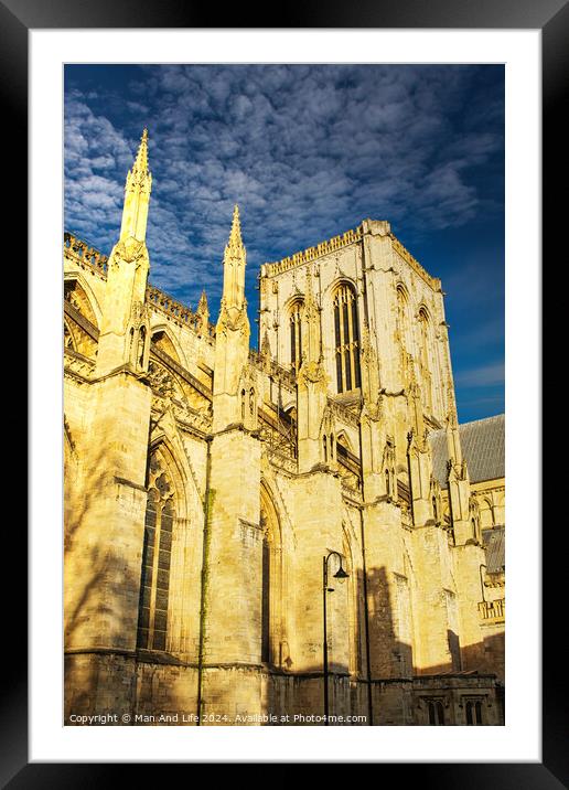 Gothic cathedral facade with spires against a clear blue sky at sunset, showcasing historical architecture in York, UK. Framed Mounted Print by Man And Life