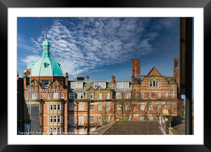 Vintage building with a green dome under a blue sky with fluffy clouds, viewed from a window in Harrogate, England. Framed Mounted Print by Man And Life