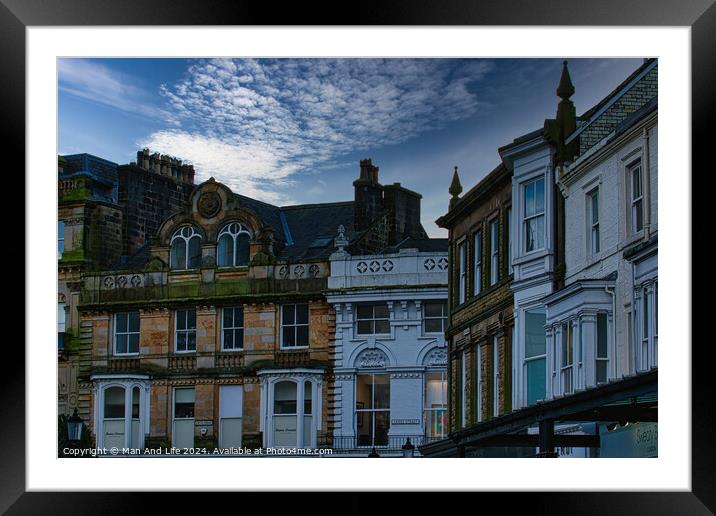 Quaint European street with historic architecture under a dramatic cloudy sky at dusk in Harrogate, England. Framed Mounted Print by Man And Life