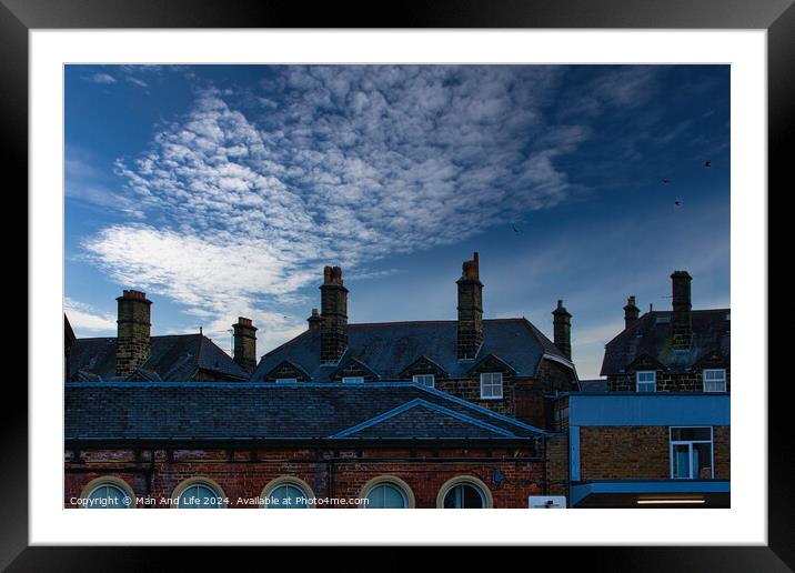 Dramatic sky over silhouette of traditional buildings with distinctive chimneys at dusk in Harrogate, England. Framed Mounted Print by Man And Life
