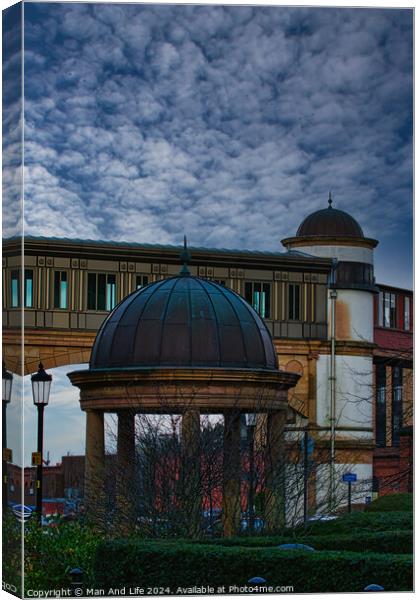 Dramatic sky over an architectural dome and building with a bridge in the background in Harrogate, England. Canvas Print by Man And Life