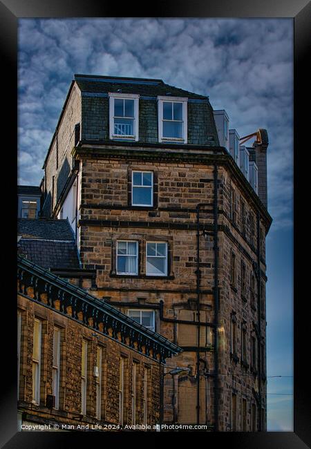 Vintage building corner against a dramatic cloudy sky in Harrogate, England. Framed Print by Man And Life