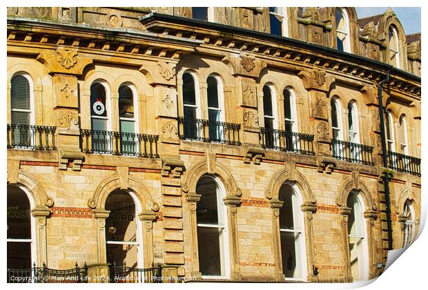 Vintage brick building facade with ornate windows and architectural details under a clear blue sky in Harrogate, England. Print by Man And Life
