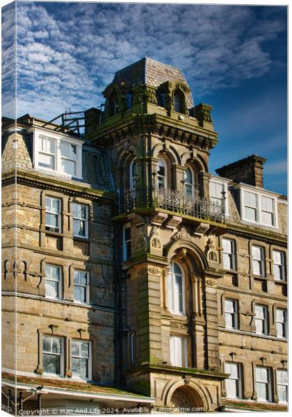 Victorian architecture with ornate details on a historic building against a blue sky with clouds in Harrogate, England. Canvas Print by Man And Life