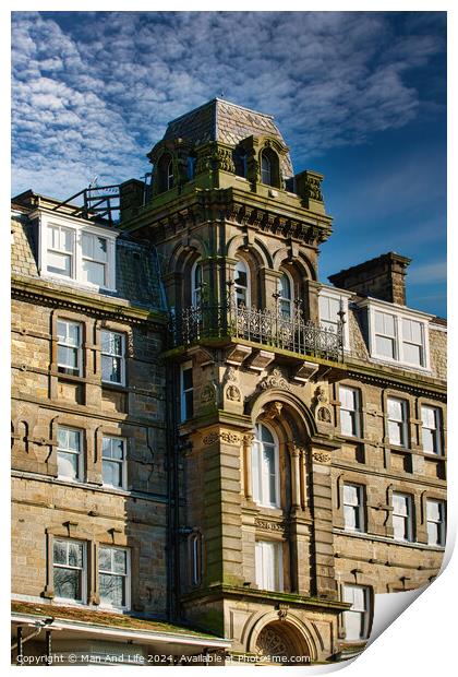 Victorian architecture with ornate details on a historic building against a blue sky with clouds in Harrogate, England. Print by Man And Life