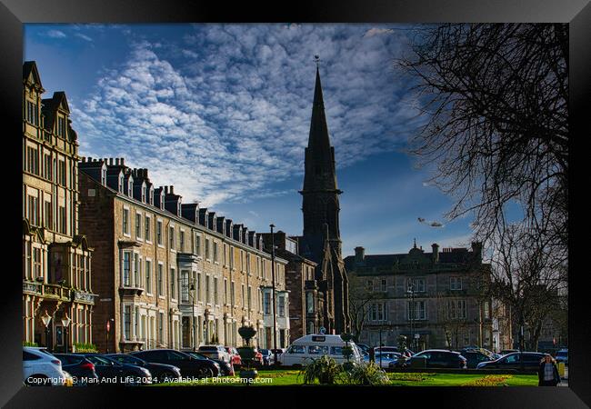 Classic European street with historic architecture and a church spire under a dramatic cloudy sky in Harrogate, England. Framed Print by Man And Life