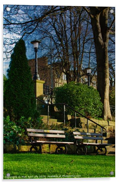 Tranquil park scene with empty benches, lush greenery, and a street lamp against a clear blue sky in Harrogate, England. Acrylic by Man And Life