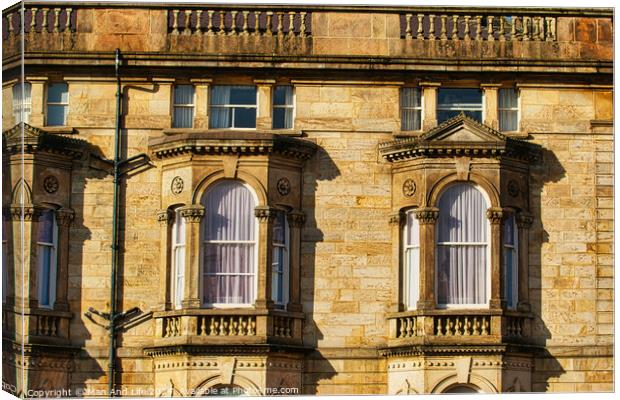 Close-up of a classic sandstone building facade with ornate windows and architectural details in warm sunlight in Harrogate, England. Canvas Print by Man And Life