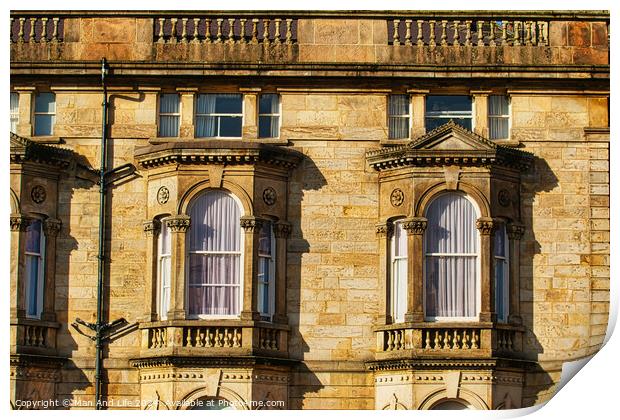 Close-up of a classic sandstone building facade with ornate windows and architectural details in warm sunlight in Harrogate, England. Print by Man And Life