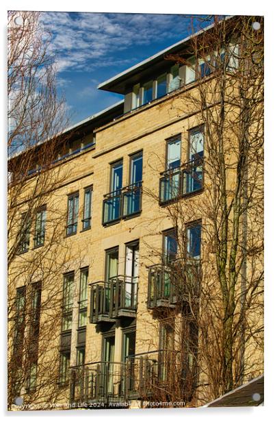 Facade of a modern apartment building with balconies, framed by leafless trees against a clear blue sky in Harrogate, England. Acrylic by Man And Life