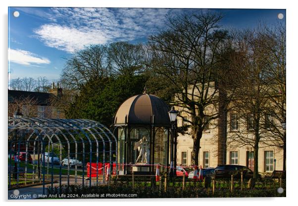 Urban park scene with modern glass pavilion, traditional street lamp, and lush trees under a blue sky with wispy clouds in Harrogate, England. Acrylic by Man And Life