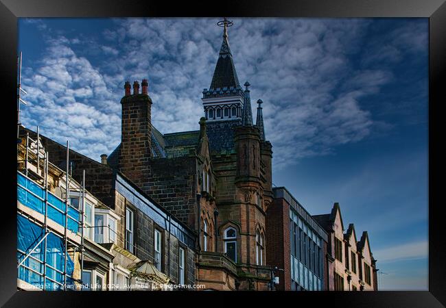 Historic architecture with a spire against a dramatic sky, flanked by modern buildings and scaffolding in Harrogate, England. Framed Print by Man And Life