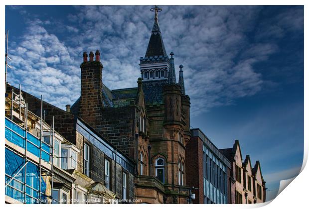 Historic architecture with a spire against a dramatic sky, flanked by modern buildings and scaffolding in Harrogate, England. Print by Man And Life