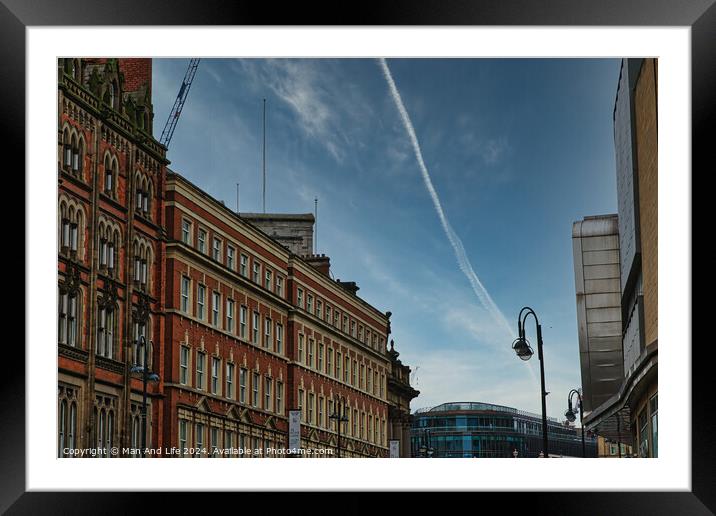 Urban street view with historic buildings under a clear blue sky with contrails in Leeds, UK. Framed Mounted Print by Man And Life