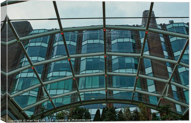 Modern glass building facade viewed through a transparent arched ceiling, showcasing urban architecture in Leeds, UK. Canvas Print by Man And Life