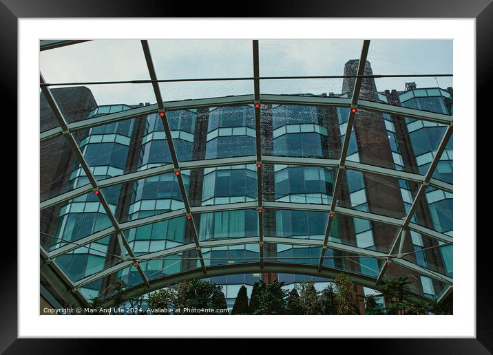 Modern glass building facade viewed through a transparent arched ceiling, showcasing urban architecture in Leeds, UK. Framed Mounted Print by Man And Life