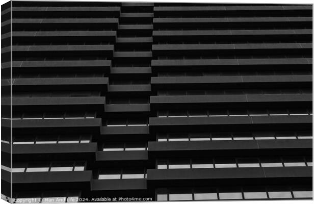 Monochrome image of modern building facade with geometric pattern of windows and ledges, abstract urban background in Leeds, UK. Canvas Print by Man And Life