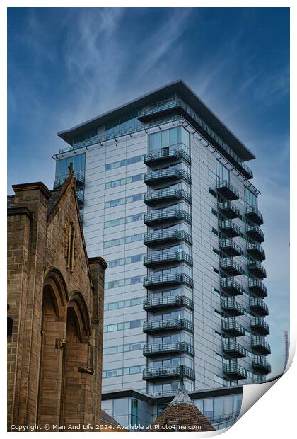 Contrast of old and new architecture with a modern glass skyscraper towering behind a traditional stone church under a clear blue sky in Leeds, UK. Print by Man And Life