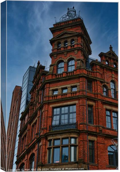 Victorian red brick building with ornate architecture against a dramatic cloudy sky, showcasing a contrast of historical and modern urban design in Leeds, UK. Canvas Print by Man And Life