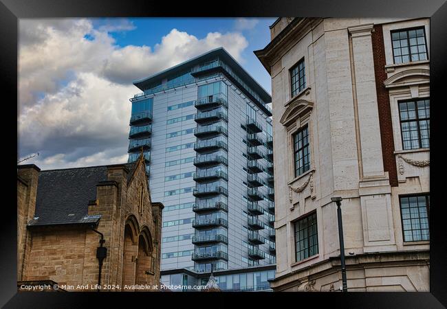Modern glass skyscraper towering over historic buildings under a cloudy sky in Leeds, UK. Framed Print by Man And Life