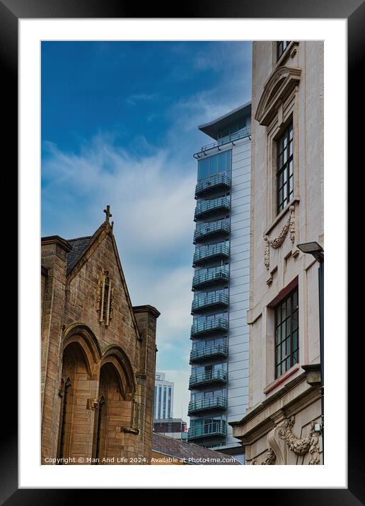 Contrast of old and new architecture with a historic church in the foreground and a modern skyscraper in the background against a blue sky in Leeds, UK. Framed Mounted Print by Man And Life