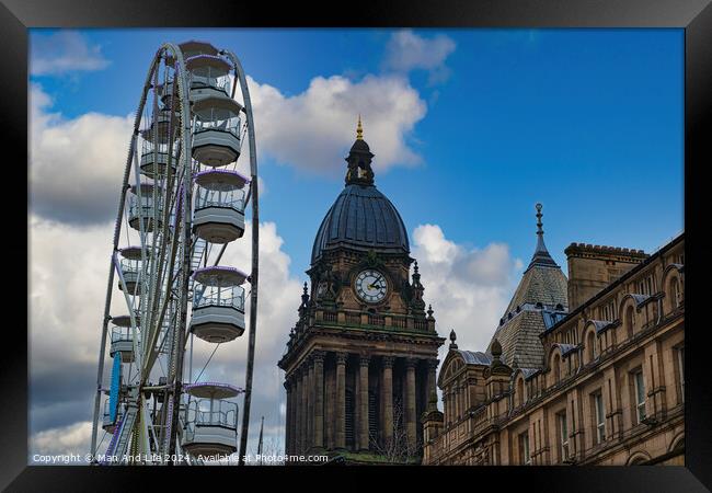 Ferris wheel beside a historic clock tower under a blue sky with clouds in Leeds, UK. Framed Print by Man And Life