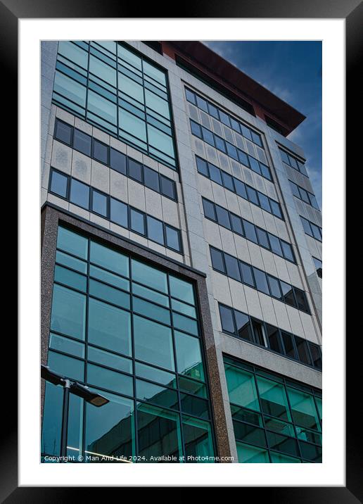 Modern office building facade with reflective glass windows against a blue sky in Leeds, UK. Framed Mounted Print by Man And Life