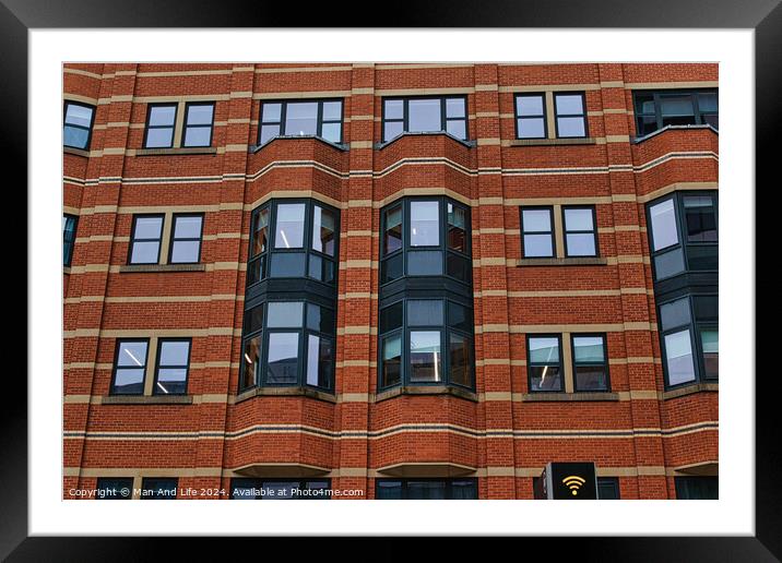 Modern brick building facade with patterned windows and architectural details in Leeds, UK. Framed Mounted Print by Man And Life