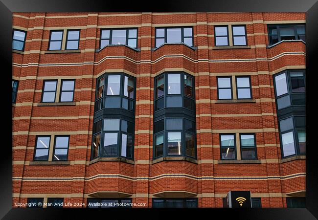 Modern brick building facade with patterned windows and architectural details in Leeds, UK. Framed Print by Man And Life