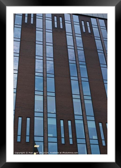 Modern building facade with a pattern of windows and brickwork against a blue sky in Leeds, UK. Framed Mounted Print by Man And Life