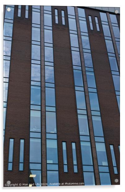 Modern building facade with a pattern of windows and brickwork against a blue sky in Leeds, UK. Acrylic by Man And Life