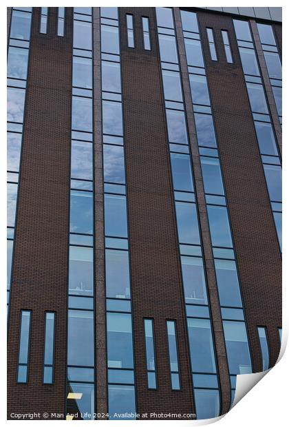 Modern building facade with a pattern of windows and brickwork against a blue sky in Leeds, UK. Print by Man And Life