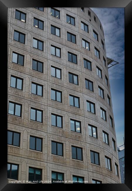Modern curved office building facade against a clear blue sky in Leeds, UK. Framed Print by Man And Life