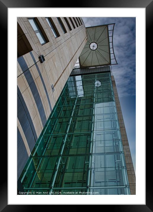 Modern architectural detail with glass facade and clock tower against a blue sky in Leeds, UK. Framed Mounted Print by Man And Life