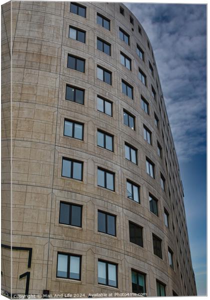 Curved modern office building facade with symmetric windows against a cloudy sky in Leeds, UK. Canvas Print by Man And Life