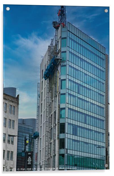 Modern glass building facade with reflections under a cloudy sky, surrounded by urban architecture in Leeds, UK. Acrylic by Man And Life