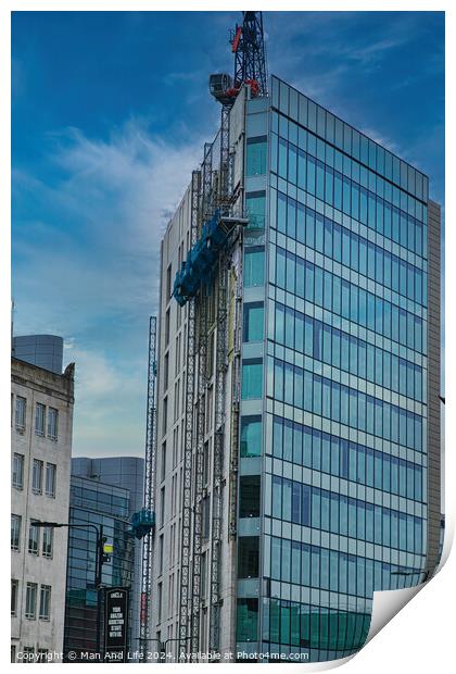 Modern glass building facade with reflections under a cloudy sky, surrounded by urban architecture in Leeds, UK. Print by Man And Life