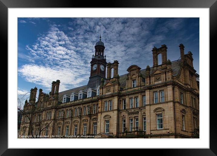 Historic European architecture with a clock tower under a dramatic cloudy sky in Leeds, UK. Framed Mounted Print by Man And Life