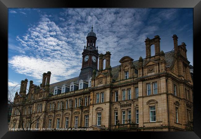 Historic European architecture with a clock tower under a dramatic cloudy sky in Leeds, UK. Framed Print by Man And Life