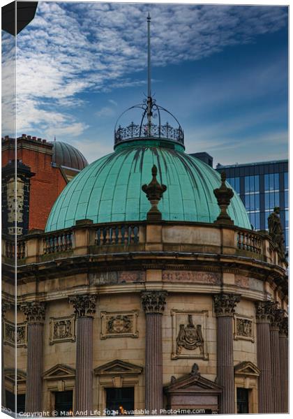 Vintage green dome of a classical building against a blue sky with modern skyscrapers in the background in Leeds, UK. Canvas Print by Man And Life
