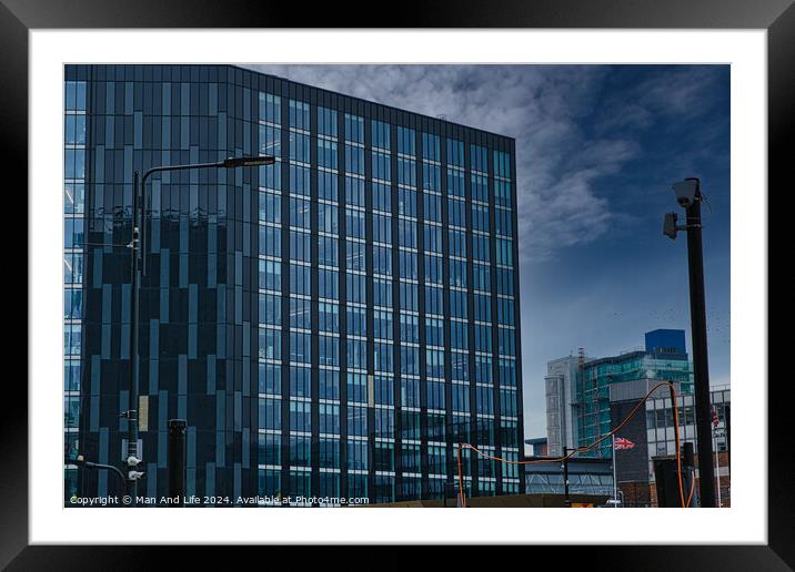 Modern glass office buildings with reflections under blue sky in Leeds, UK. Framed Mounted Print by Man And Life