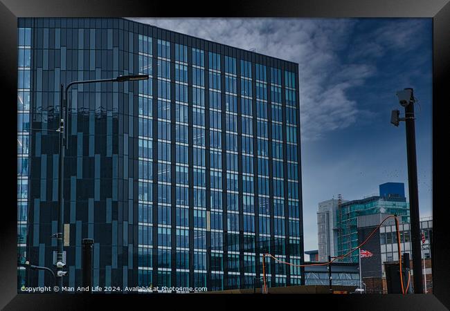 Modern glass office buildings with reflections under blue sky in Leeds, UK. Framed Print by Man And Life