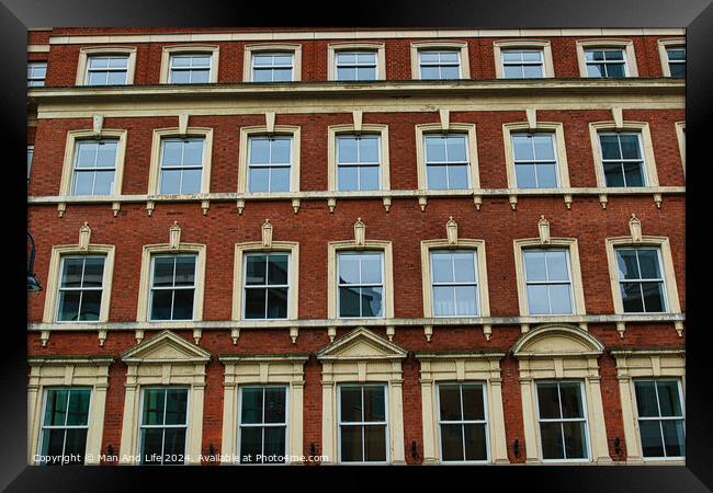 Facade of a classic red brick building with symmetrical windows against a clear sky in Leeds, UK. Framed Print by Man And Life