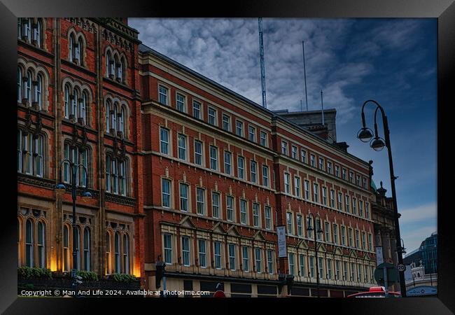 Historic red brick building at dusk with street lamp and dramatic sky in Leeds, UK. Framed Print by Man And Life