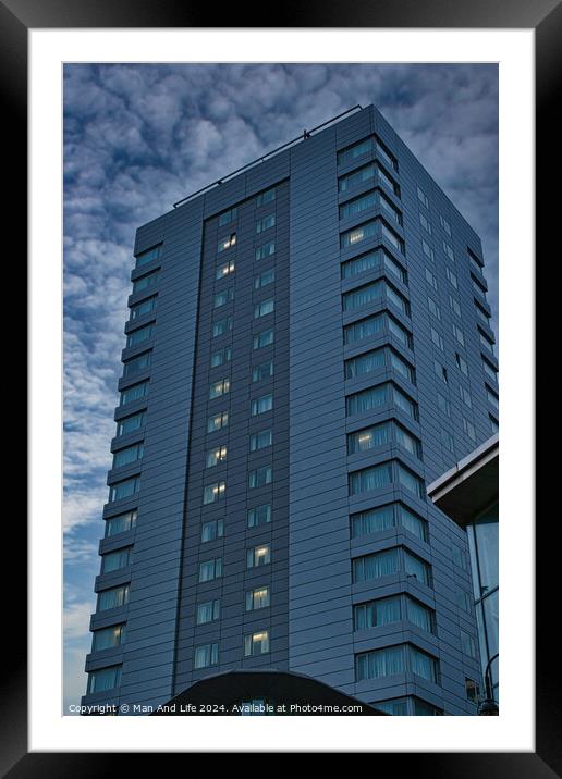 Modern high-rise building against a cloudy sky at dusk in Leeds, UK. Framed Mounted Print by Man And Life
