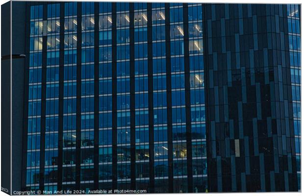 Modern office building facade with reflective glass windows at dusk in Leeds, UK. Canvas Print by Man And Life