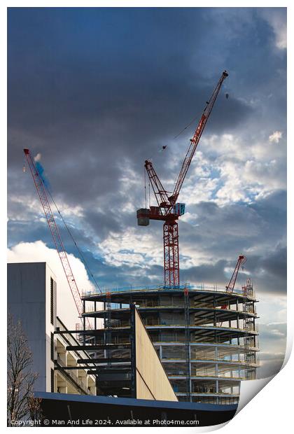 Construction site with cranes against a dramatic cloudy sky, symbolizing development and architecture in Liverpool, UK. Print by Man And Life