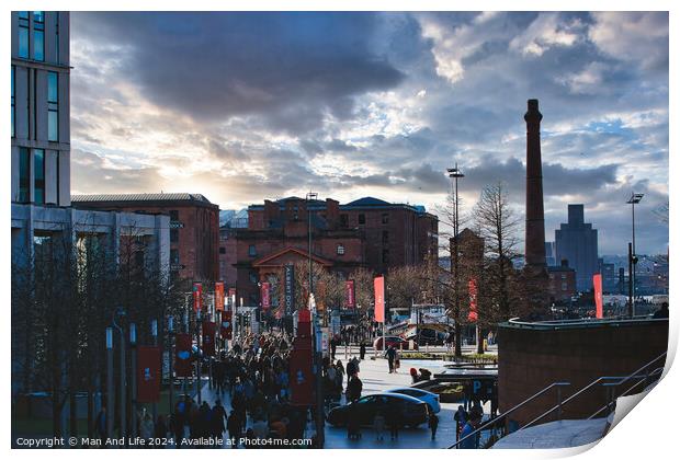 Dramatic urban sunset with silhouetted buildings and vibrant sky, people walking in a cityscape in Liverpool, UK. Print by Man And Life